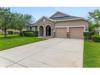 Charming single-story home featuring a stone accented facade, well-manicured lawn, and a spacious two car garage at 32 Abacus Ave, Ormond Beach, FL 32174