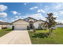 Charming single-story home featuring a two-car garage, landscaped yard, and a welcoming entrance at 3810 Arboreal Ct, Deland, FL 32724