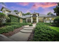 Charming home featuring lush landscaping, inviting walkway, and elegant architectural details at 420 Greenridge Ct, Debary, FL 32713