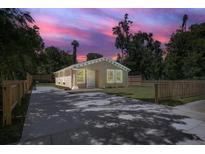 Charming single-story home featuring a well-manicured lawn and a long, paved driveway at 429 W Carolina Ave, Deland, FL 32720