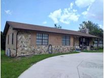 Charming single-story home featuring stone accents and a spacious front yard with a concrete driveway at 5759 Dogwood Rd, Port Orange, FL 32127