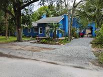 Charming blue home featuring well-kept landscaping and a welcoming front entrance at 615 Weber Ave, Daytona Beach, FL 32114
