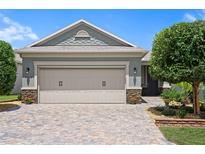Charming home featuring a spacious garage, lovely stone accents and a beautifully landscaped yard at 7732 Sw 86Th Ct, Ocala, FL 34481