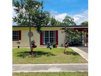 Charming single-story home featuring a well-maintained front yard and red trim at 1025 Persian St, Deltona, FL 32725
