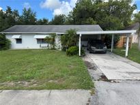 Charming single story home with a carport and mature trees at 110 Amigos Rd, Debary, FL 32713
