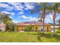 Charming home featuring solar panels, mature landscaping, and a welcoming front entrance at 1131 Lemonwood Ave, Deland, FL 32724