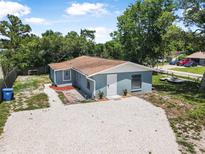 Charming home with a gravel driveway and lush greenery, creating a welcoming and serene ambiance at 1214 Flomich St, Daytona Beach, FL 32117