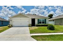 Charming single-story home with a well-manicured lawn and attached two-car garage in a desirable neighborhood at 1216 August Sky Dr, Deltona, FL 32738