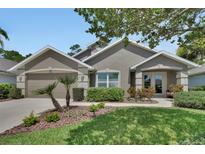 Charming home exterior showcasing manicured landscaping and a welcoming front entrance at 1329 Sunningdale Ln, Ormond Beach, FL 32174