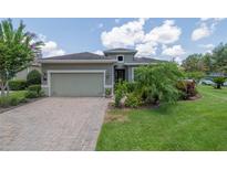 Charming single-story home boasts a well-manicured lawn and neutral colored exterior paint at 1653 Victoria Gardens Dr, Deland, FL 32724