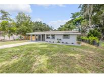 Charming single-story home with a well-maintained lawn and covered front porch for relaxing in the beautiful weather at 173 Cedar Ave, Orange City, FL 32763
