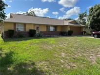 Charming single-story home featuring a well-maintained lawn and attached two-car garage at 1887 Viking Ave, Deltona, FL 32725