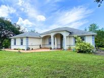 Charming single-story home with a beautifully landscaped front yard and inviting arched entryway at 19320 Oberly Pkwy, Orlando, FL 32833