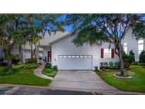 Charming home with a well-maintained yard, white siding, attached garage and an inviting front porch at 232 River Village Dr, Debary, FL 32713