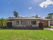 Charming single-story home featuring a well-maintained lawn and neutral color palette at 2526 Victory Palm Dr, Edgewater, FL 32141