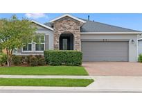 Charming single-Gathering home featuring a stone accent entrance and well-maintained landscaping at 5648 Nw 40Th Loop, Ocala, FL 34482