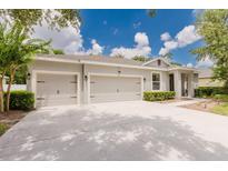 Charming single-Gathering home with a well-maintained lawn and a spacious three-car driveway at 565 Morgan Wood Dr, Deland, FL 32724