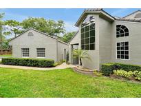 Charming home featuring a landscaped yard and stucco exterior, with an arched window and lovely curb appeal at 3988 Radley Ct, Longwood, FL 32779