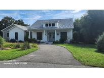 Charming home featuring a well-manicured lawn and a welcoming front porch at 2719 Brookline Ave, New Smyrna Beach, FL 32168