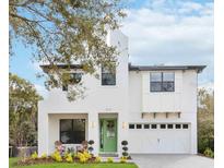 Two-story white house with green door, two-car garage, and manicured lawn at 1018 Stetson St, Orlando, FL 32804