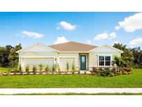 One-story home with light-colored siding, two-car garage, and landscaped lawn at 1946 Quail Fields Cir, Winter Haven, FL 33884