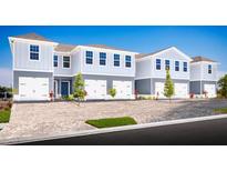 Charming two-story townhomes featuring two-car garages and stylish blue and gray exterior paint at 2304 Incandescent Way, South Daytona, FL 32119