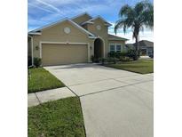Two-story house with a two-car garage and well-maintained lawn at 2588 Egret Loop, Kissimmee, FL 34743