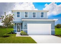 Charming two-story home with a well-manicured lawn, blooming tree, and a two-car garage at 5043 Bear Lake Loop, Deland, FL 32724