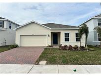 Attractive single-story home with a brick paved driveway and well-manicured lawn at 380 Crossings Ave, St Cloud, FL 34771