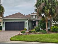 Well-maintained home with a two-car garage and lush landscaping at 8320 Sw 82Nd Loop, Ocala, FL 34481