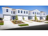 Two-story townhouses with attached garages and landscaping at 2302 Incandescent Way, South Daytona, FL 32119