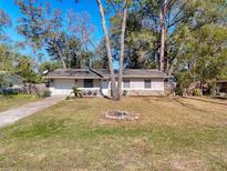 Charming single-story home with a well-manicured lawn, a classic front door, and an attached garage at 1531 Ne 38Th St, Ocala, FL 34479