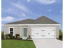 Charming single Gathering home showcasing a well-manicured lawn and a two car garage at 2183 Oklahoma Dr, Sumterville, FL 33585