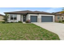 Charming single-Gathering home featuring a well-manicured lawn and a two-car garage at 9773 Sw 63Rd Loop, Ocala, FL 34481