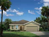 Inviting single-story home featuring a two-car garage, well-manicured lawn, and tropical landscaping with palm trees at 1180 Ivy Manor St, Minneola, FL 34715