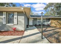 Charming single-story home featuring stone accents, tidy landscaping, and a well-maintained walkway at 20995 Sw 93Rd Lane Rd, Dunnellon, FL 34431