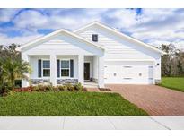 Charming single-story home showcasing a well-manicured lawn and a brick-paved driveway, offering a blend of comfort and curb appeal at 4220 Cattail Marsh Dr, Lakeland, FL 33811
