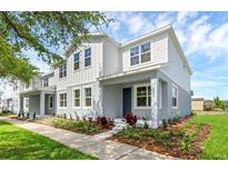 Beautiful, new construction two-story townhome with a covered porch and professionally landscaped yard at 3323 Grande Heron Dr, St Cloud, FL 34773