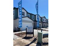 New construction townhomes featuring Hardie siding, brick paver driveways, and designer-selected exterior colors at 2465 Magnolia Reserve Rd, Ocoee, FL 34761