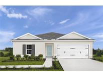 Charming single-story home with a two-car garage, blue front door, and well-manicured lawn at 403 Harvard Ct, Dundee, FL 33838