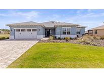 Charming single-story home with a well-manicured lawn, neutral paint, and a two-car garage at 9262 Sw 102Nd Avenue Rd, Ocala, FL 34481