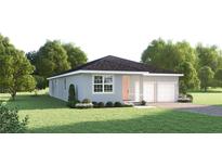 Charming single-story home featuring a well-manicured lawn, a two-car garage, and lovely landscaping at 114 Venetian Palms Blvd, New Smyrna Beach, FL 32168