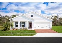 Beautiful single-Gathering home featuring a brick driveway, two car garage, and a well-manicured front lawn at 1381 Laramie Way, Haines City, FL 33844