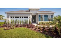 Charming single-story home with manicured lawn, colorful landscaping, and attached two car garage at 1556 Covey Rise Ter, Winter Haven, FL 33884