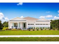 Charming single-story home featuring a well-manicured lawn, three-car garage, and tasteful landscaping at 1560 Covey Rise Ter, Winter Haven, FL 33884