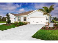 Charming single-story home featuring a three-car garage, well-manicured lawn, and stone accents at 1203 Turtle Island Rd, Lady Lake, FL 32159