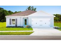 Charming single-story home featuring a colorful front door and well-manicured lawn at 420 Harvard Ct, Dundee, FL 33838