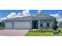 Charming single-story home with a brick driveway, manicured lawn, and a two-car garage at 2193 Aibonito Cir, Clermont, FL 34711