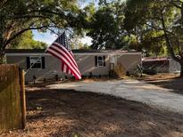 Charming single-story home with a gravel driveway and a well-maintained front yard at 3346 Se 131St Pl, Belleview, FL 34420