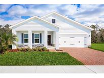 Charming single-story home featuring a brick driveway, a two car garage, and lush green lawn at 1539 Landon Ln, Haines City, FL 33844